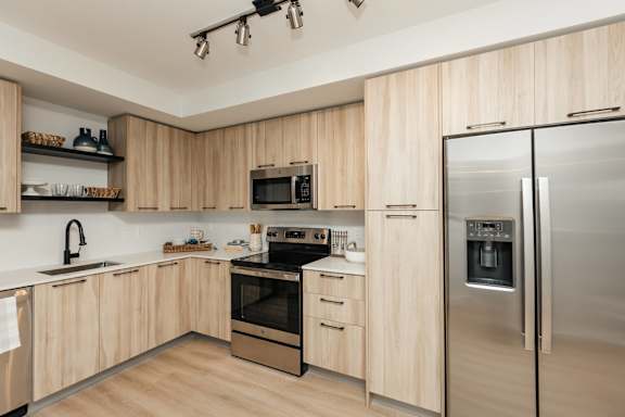 a kitchen with wooden cabinets and stainless steel appliances