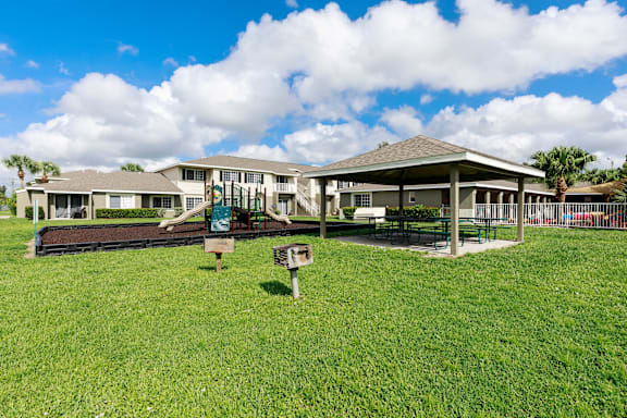 A large building with a green lawn in front.