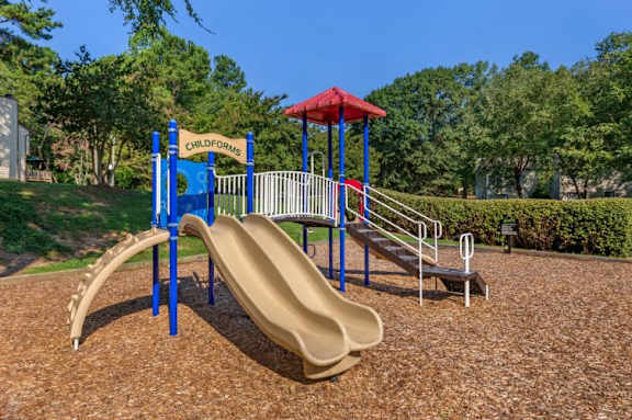 Colorful Playground  on Mulch with Treeline in the Background at Regency Park Apartment Homes, Raleigh, North Carolina