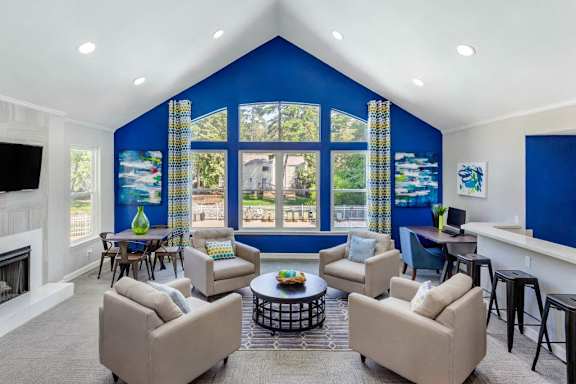 Clubhouse Seating Area with Grey Armchairs Around Coffee Table at Regency Park Apartment Homes, North Carolina, 27616