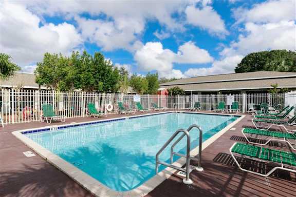 A large outdoor swimming pool surrounded by sun loungers.