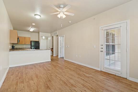living room with hardwood-style flooring and ceiling fan