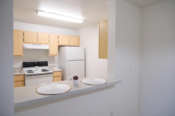 A kitchen with a stove, oven, and refrigerator.