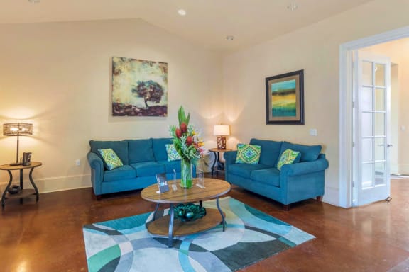 Clubhouse Seating Area with 2 Blue Couches Coffee Table on Area Rug