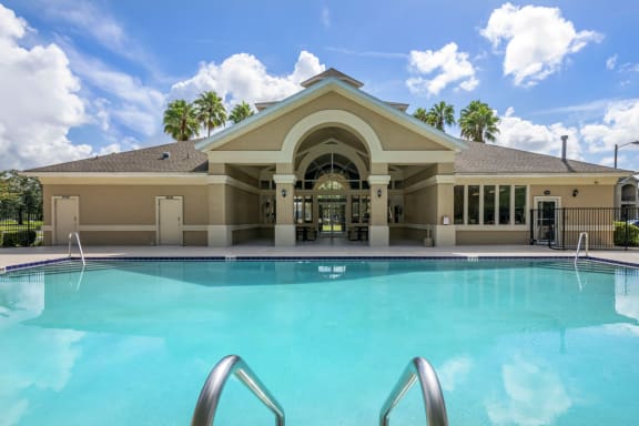 a large swimming pool in front of a building