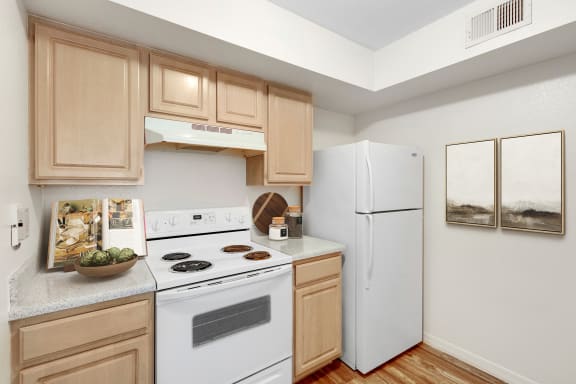 a kitchen with white appliances and wooden cabinets