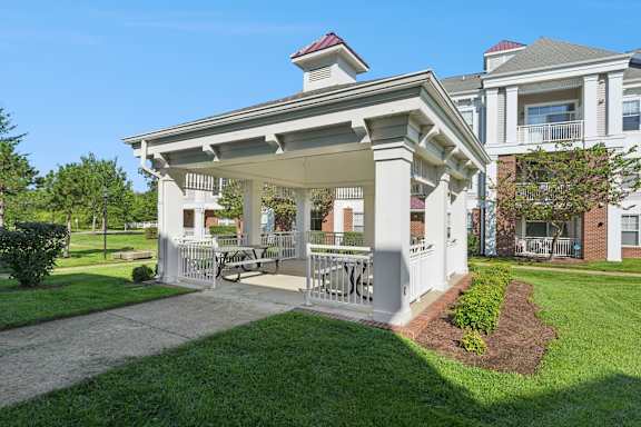 A white building with a porch and a sign that reads "NICE".