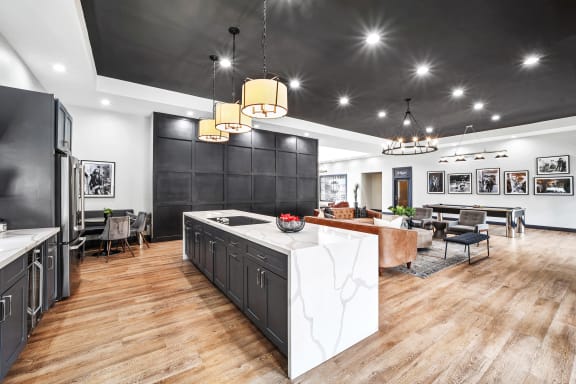 clubhouse kitchen with dark cabinetry, white countertops, and nearby seating