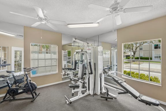 Fitness room with workout equipment in front of a mirror