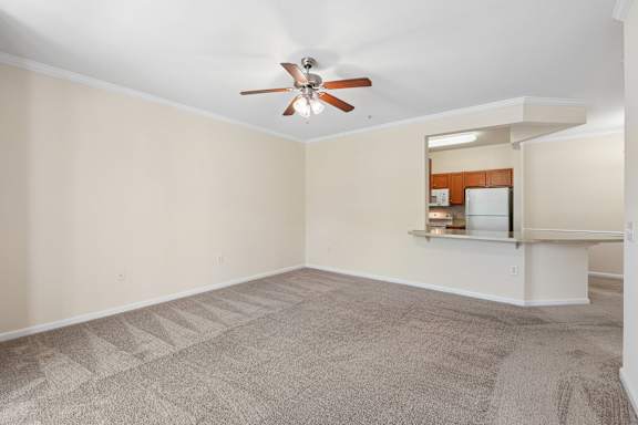 A room with a ceiling fan and carpeted floor.