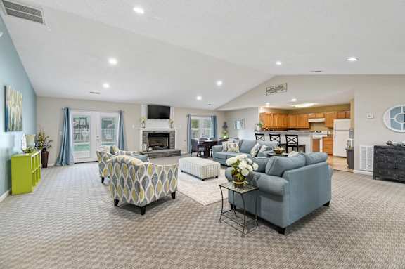 A clubhouse with a grey sofa and a patterned armchair.