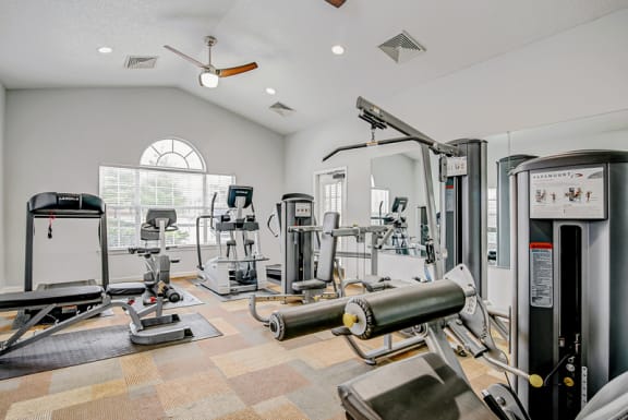 the resident fitness center with exercise equipment at the oxford at tech ridge apartments in austin