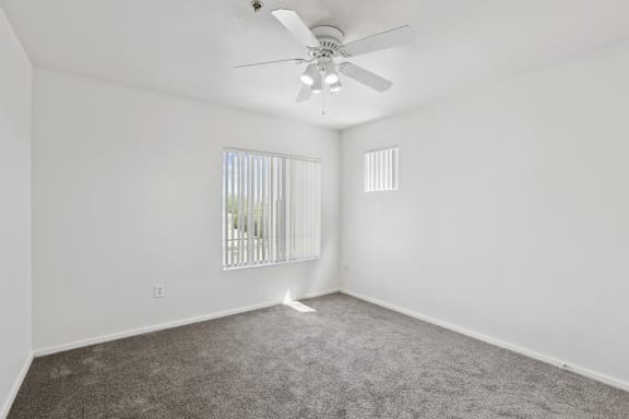 Grey floor with ceiling fan at The Village at Sun Valley Apartments, Mesa
