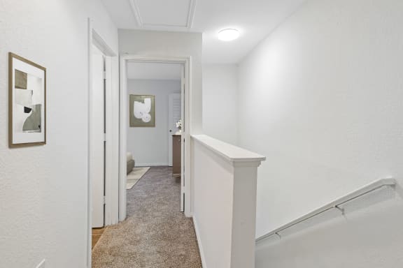 a hallway with white walls and white trim