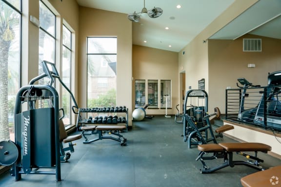 a fitness room with weights and other exercise equipment