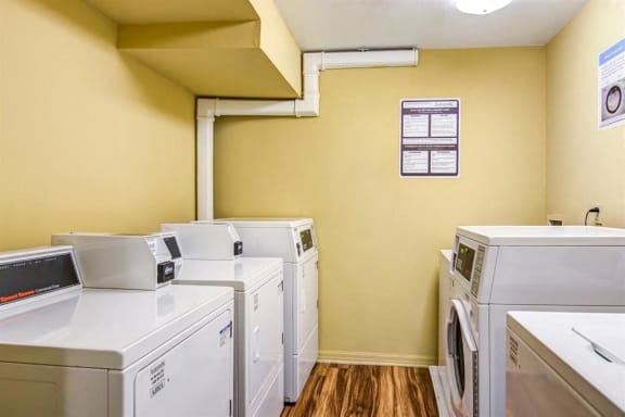 Yellow Laundry Facility with Washer and Dryers