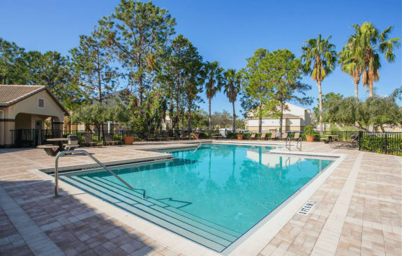 Swimming Pool with Lounge Seating and Clubhouse in the Background