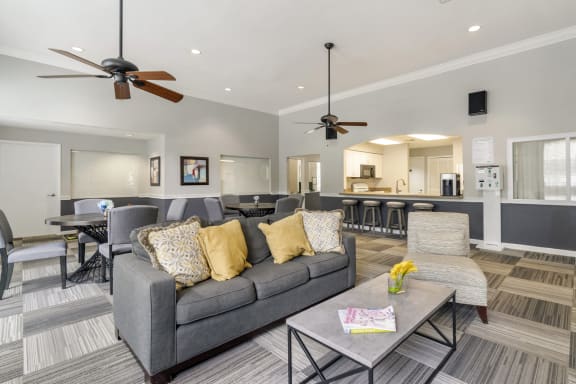 clubhouse with couch and tables and chairs behind