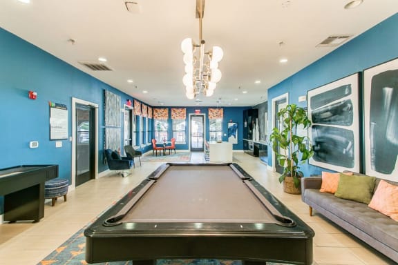 a game room with a pool table and a couch