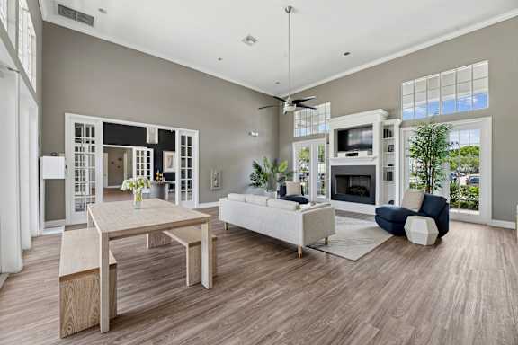 A modern clubhouse with a dining table and a sofa.