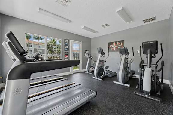 A well equipped gym with treadmills, exercise bikes and other equipment.