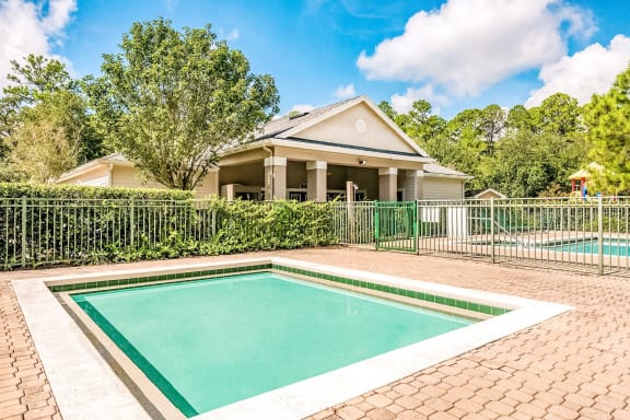 Wading pool with a brick paver sundeck.