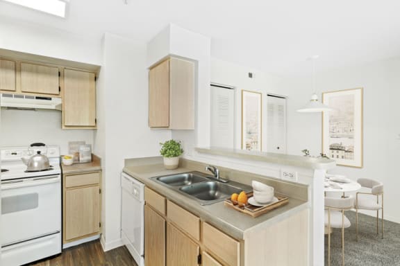 a kitchen with white appliances and wooden cabinets