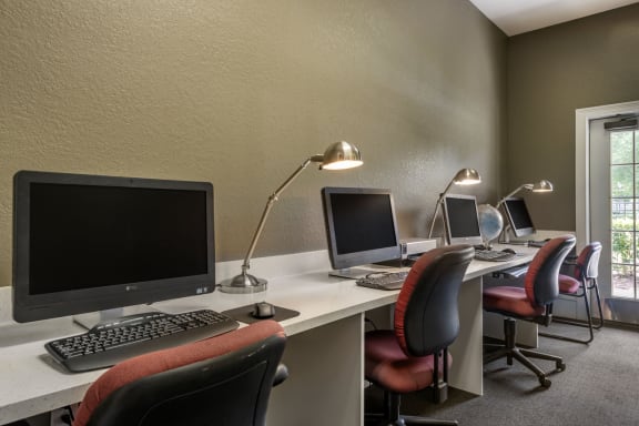 Business center filled with computer monitors and chairs