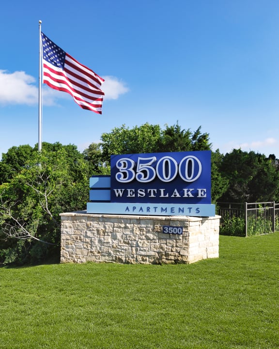 a sign with an american flag in the background