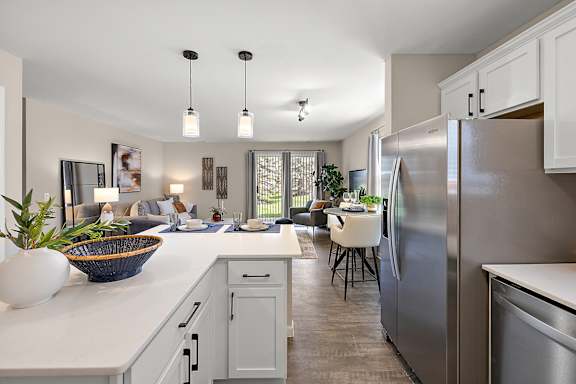 A modern kitchen with a large island and stainless steel appliances.