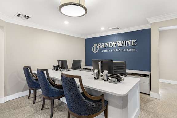 A room with a desk and chairs with a sign that says BrandyWine.