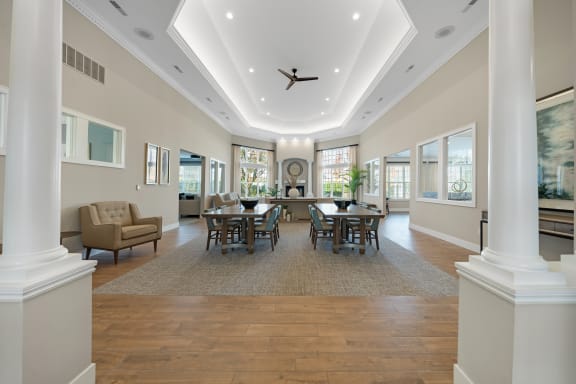 a large dining room with a table and chairs and a ceiling fan