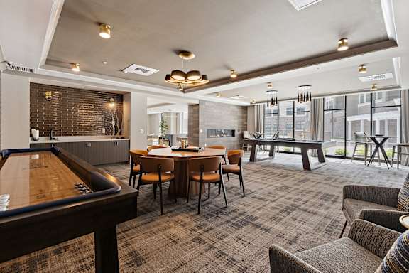 a resident clubhouse with a pool table shuffleboard and a foosball table  at The Griffin Royal Oak, Michigan, 48067