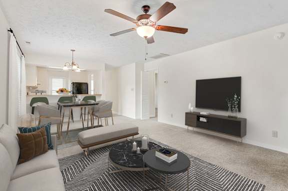 a living room with a couch and a ceiling fan at Hunter's Ridge Apartments, Apartments, Fayetteville, NC