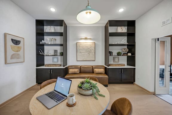 A modern living room with a laptop on the table.