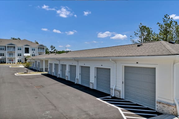 A row of garages in front of a building.