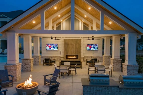 A cozy outdoor patio with a fire pit and seating area.