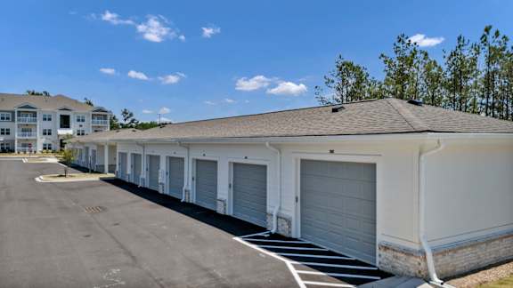 A row of garage doors in front of a building.