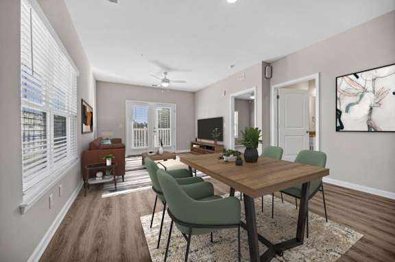A dining room with a wooden table and green chairs.