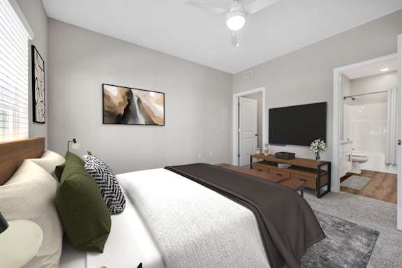 A bedroom with a large bed and a flat screen TV.