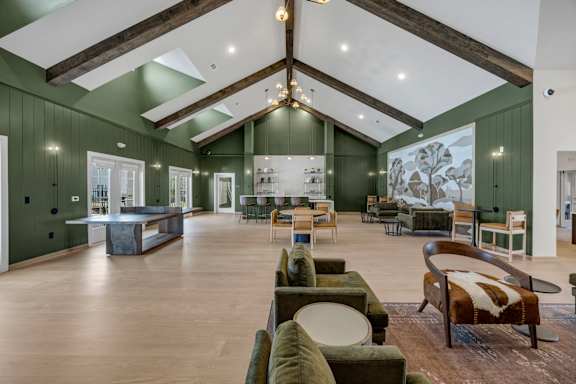A large room with a green wall and a wooden floor.