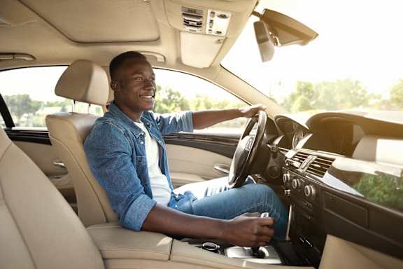 A man is driving a car.