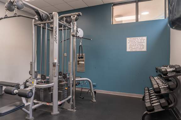 A gym with a blue wall and a sign that says "No Smoking".