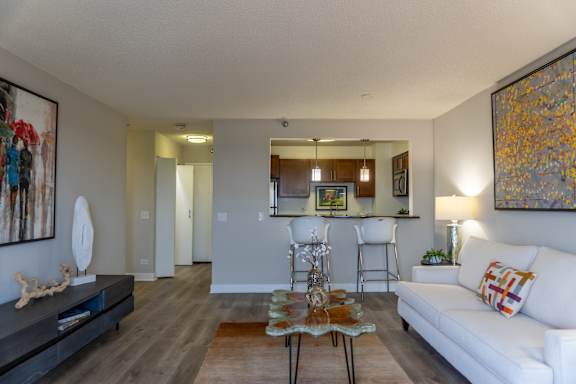 A living room with a white couch and a coffee table.