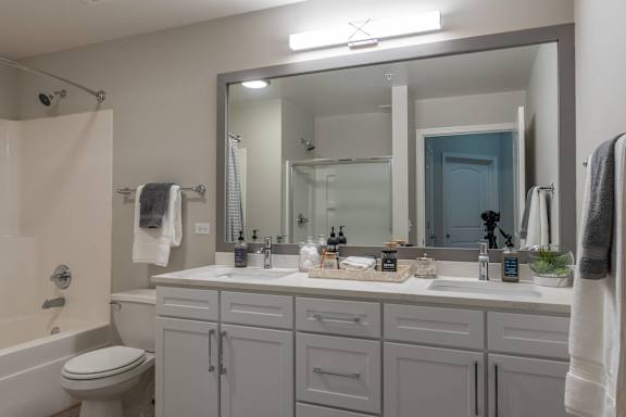 A bathroom with a white toilet, a white sink, and a white bathtub.