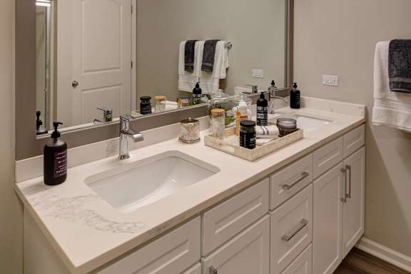 A bathroom with a white sink and a mirror.