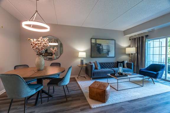 A modern living room with a dining table and chairs.