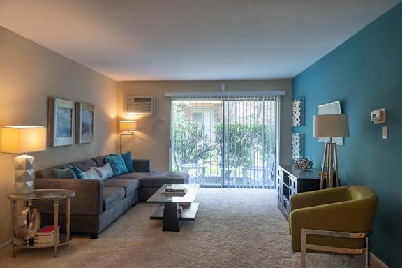 A living room with a grey couch and a yellow chair.