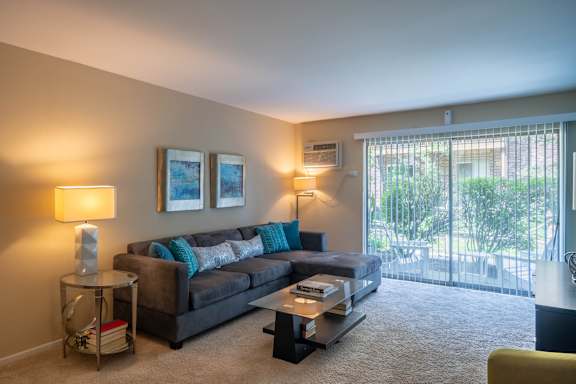 A living room with a grey couch and a coffee table.