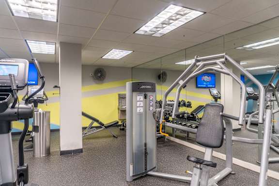 A gym with a variety of equipment including a leg press machine.